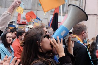 Yvette Benarroch says Angie Nixon’s bullhorn protest left her with possible ear damage, files workers’ comp claim