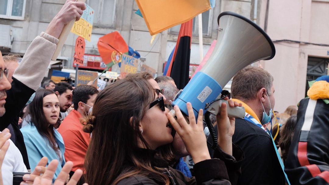 Yvette Benarroch says Angie Nixon’s bullhorn protest left her with possible ear damage, files workers’ comp claim